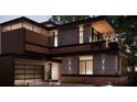 Contemporary home with dark exterior, balcony, and attached garage at 627 Country Club Dr, Winter Park, FL 32789