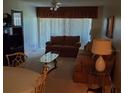 Living room with sectional sofa and glass coffee table at 6182 Willowpointe # B201, Orlando, FL 32822