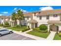 Townhouses with tile roofs, landscaping, and parking at 1552 Plunker Dr, Davenport, FL 33896