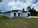 Modern house exterior with a white and black color scheme, showcasing the side of the house at 15096 Sw 51St Ave, Ocala, FL 34473