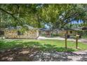 Stone home with double doors and large trees at 3355 Scarlet Dr, Sanford, FL 32773