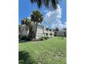Condo building with lush green lawn and palm trees at 1059 S Hiawassee Rd # 1824, Orlando, FL 32835