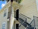 Exterior view of condo building with stairs and landscaping at 1059 S Hiawassee Rd # 1824, Orlando, FL 32835