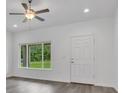 Bright living room featuring vinyl plank flooring and a ceiling fan at 297 Malauka Run, Ocklawaha, FL 32179