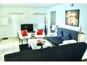 Bright and airy living room featuring comfortable seating and a flat-screen TV at 4146 Versailles Dr # 4146D, Orlando, FL 32808