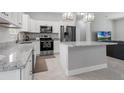 Modern kitchen with stainless steel appliances and breakfast bar at 370 Routh Ave, New Smyrna Beach, FL 32168