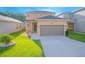 Two-story house with brown garage door and landscaping at 1146 Atlantic Ave, Fruitland Park, FL 34731