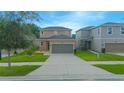 Two-story house with brown garage door and landscaping at 1146 Atlantic Ave, Fruitland Park, FL 34731