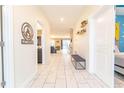Bright and spacious entryway with tile flooring and bench at 4562 Narrative Ln, Kissimmee, FL 34746