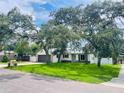 Attractive single story home nestled amongst lush landscaping and mature trees at 1393 Beverly Ln, Casselberry, FL 32707