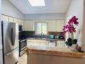 Bright kitchen featuring stainless steel appliances and a breakfast bar at 1393 Beverly Ln, Casselberry, FL 32707
