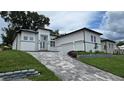 Modern house with gray stone driveway and landscaping at 555 Sanctuary Golf Pl, Apopka, FL 32712