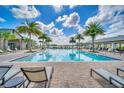 Inviting community pool with lounge chairs and palm trees at 2854 Black Birch Dr, Ocoee, FL 34761
