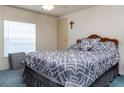 Bedroom with a double bed, gray bedding, and blue carpet at 550 Saint Johns Rd, Tavares, FL 32778