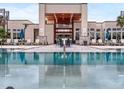 Resort-style pool with clubhouse and outdoor seating at 7740 Sandy Ridge Dr # 234, Reunion, FL 34747