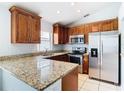 Kitchen features granite countertops and stainless steel appliances at 428 Short Pine Cir, Orlando, FL 32807