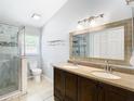 Double vanity bathroom with marble shower and tile floors at 428 Short Pine Cir, Orlando, FL 32807