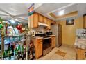 Kitchen with wood cabinets, granite countertops, and stainless steel appliances at 1759 Tallo Way, Orlando, FL 32818