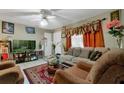 Living room with tiled floors, beige couch, and two armchairs at 1759 Tallo Way, Orlando, FL 32818