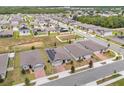 Aerial view of neighborhood with solar panels on houses at 531 Tortugas St, Haines City, FL 33844