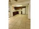 Functional kitchen with wood cabinets and tiled floor at 2222 Silver Pines Pl # 902, Orlando, FL 32808