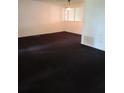 Large living room with dark carpet and plenty of natural light at 2222 Silver Pines Pl # 902, Orlando, FL 32808