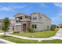 Two-story house with gray exterior and stone accents at 13839 Larkton Ln, Orlando, FL 32832