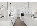 Modern kitchen with white cabinets, large island, and stainless steel appliances at 13839 Larkton Ln, Orlando, FL 32832