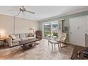 Living room features tile floors, comfortable furniture, and access to a patio at 335 N Causeway # B010, New Smyrna Beach, FL 32169