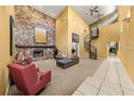 Open living area with a stone fireplace, spiral staircase, and high ceilings at 9525 Mcnorton Rd, Altamonte Springs, FL 32714