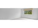 Bright bedroom with a window overlooking lush trees at 1150 Carmel Cir # 408, Casselberry, FL 32707
