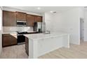 Modern kitchen with stainless steel appliances and island at 27512 Stellar Sea Way, Howey In The Hills, FL 34737