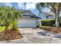 Gray two-story house with a white garage door and landscaping at 551 Cidermill Pl, Lake Mary, FL 32746