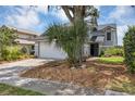 Gray two-story house with a white garage door and landscaping at 551 Cidermill Pl, Lake Mary, FL 32746