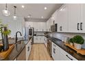 Modern kitchen with stainless steel appliances and dark granite countertops at 2590 Cavanaugh Dr, Orlando, FL 32817