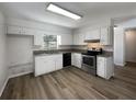 Renovated kitchen showcasing modern appliances and granite countertops at 3235 Cross Fox Dr, Mulberry, FL 33860