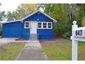 Blue house exterior with a white mailbox and landscaping at 647 S Delaware Ave, Deland, FL 32720