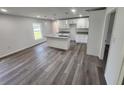 Modern kitchen featuring white cabinets, granite countertops, and a kitchen island at 2220 Church St, Sanford, FL 32771