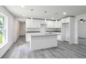 Modern kitchen with white shaker cabinets, granite countertops, and island at 2261 Greenway St, Sanford, FL 32771