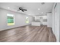 Open living room with vinyl plank flooring and kitchen island at 2261 Greenway St, Sanford, FL 32771