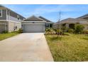 Two car garage and front yard at 6931 Wilson Pasture Ave, Groveland, FL 34736