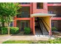 Apartment building exterior showing stairs and entrance to a unit at 3502 Windy Walk Way # 2104, Orlando, FL 32837