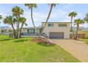 Beautiful two-story home with palm trees and brick driveway at 1232 Bel Aire Dr, Daytona Beach, FL 32118