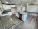 Modern kitchen with white cabinets, granite countertops, and kitchen island at 2453 Broadway St, Sanford, FL 32771
