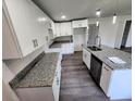 Modern kitchen with white cabinets, granite countertops, and kitchen island at 2453 Broadway St, Sanford, FL 32771