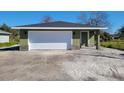 New construction home with green exterior and white garage door at 2453 Broadway St, Sanford, FL 32771