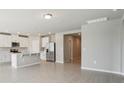 Open concept kitchen with island, stainless steel appliances, and white cabinets at 1717 Forest Run Ln, Auburndale, FL 33823