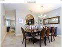 Elegant dining room featuring a large wood table and six chairs at 5299 Wildwood Way, Davenport, FL 33837