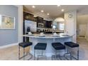 Kitchen with breakfast bar and stainless steel appliances at 5299 Wildwood Way, Davenport, FL 33837