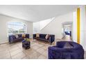 Spacious living room featuring a large sectional sofa and ample natural light at 1233 Nelson Park Court, Poinciana, FL 34759